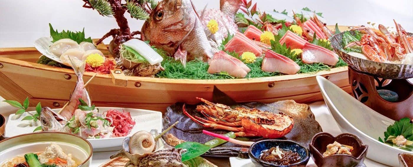 Ajiro Kanko Hotel with a generous seafood dinner featuring whole fish and shellfish.
