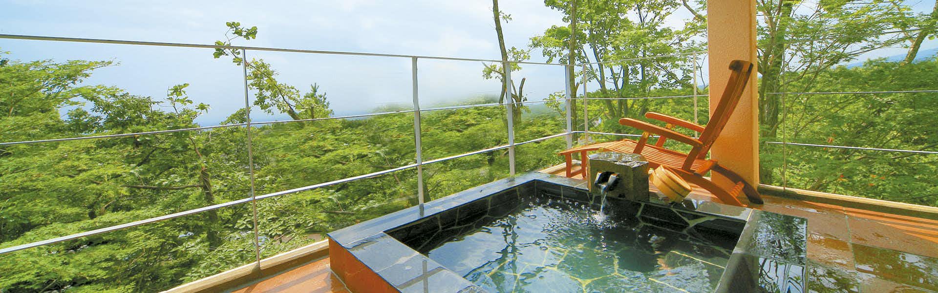Hoshi no Akari (Nasu) with this scene, where its guest-room terrace pairs a rectangular open-air bath with a sweeping green valley view.