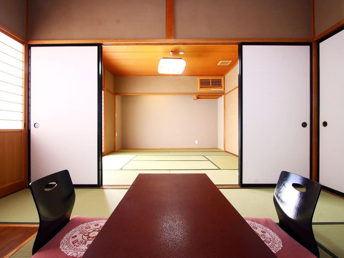 Kappo Ryokan Okaya with a compact tatami room with low table and floor chairs.