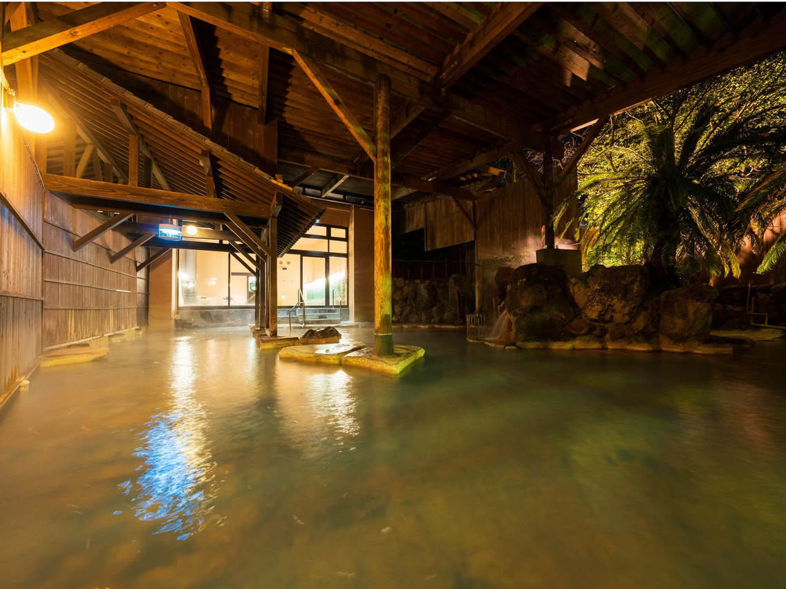 Open-air bath beneath a wooden roof.