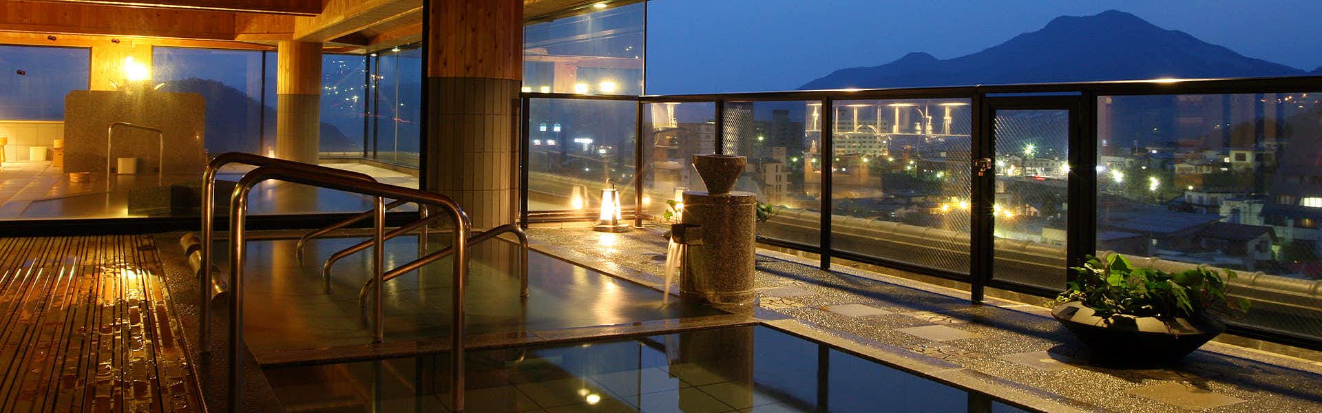 Aburaya Tosen with a rooftop bath overlooking the illuminated mountain town.