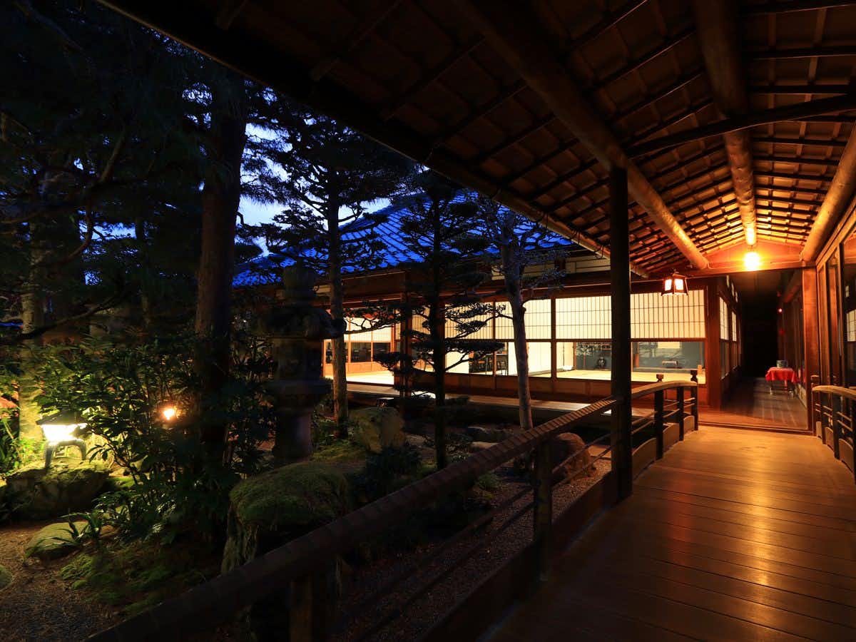 One Group Per Day Exclusive - Ryokan Restaurant Toshiyoshiya with a covered timber corridor overlooking the evening garden.