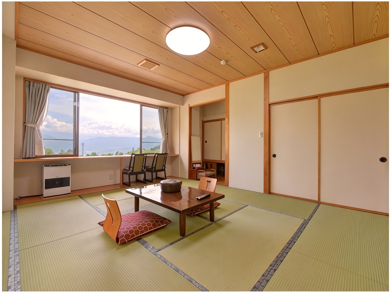 Tatami room with a low table and a wide window.