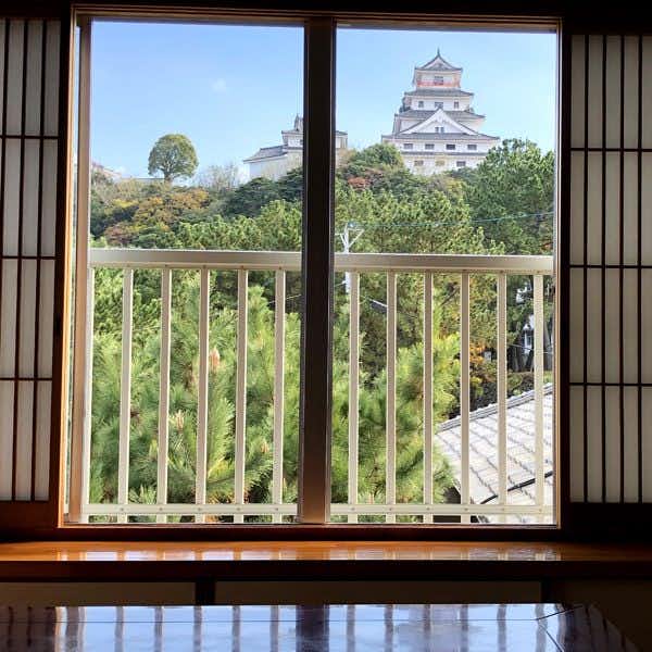 Ryokan Omasa with a framed view of Karatsu Castle beyond the guest room window.