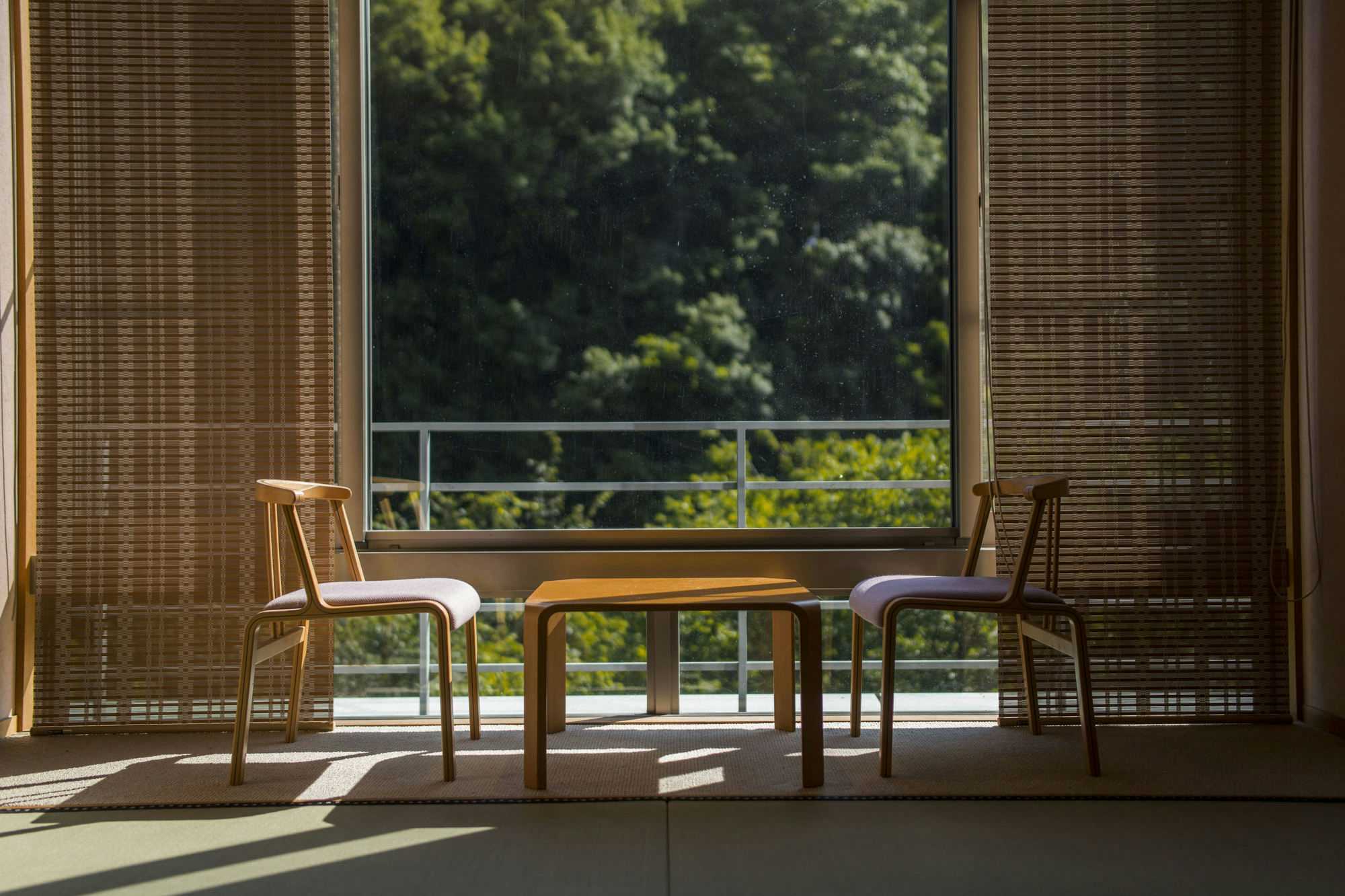 Minamitei with a guest room sitting area facing dense forest.