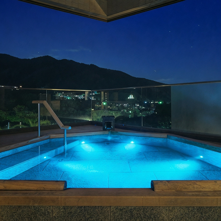 Outdoor pool beside a mountain.