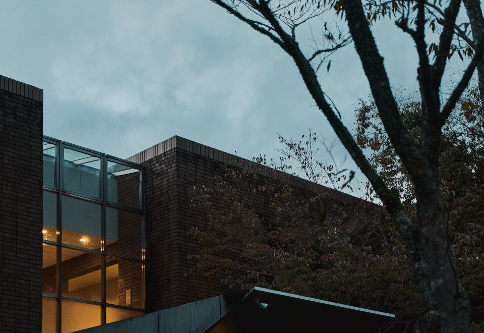 A modern hotel exterior at dusk.