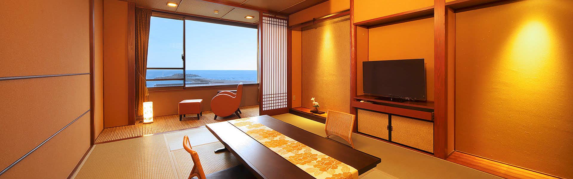 Houraiya Ryokan with an ocean-facing tatami room beneath warm amber light.