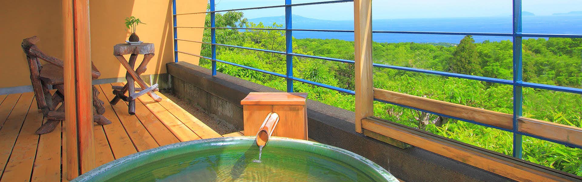 Nasu no Hana: A Healing Inn with Spectacular Views with a circular balcony bath overlooking the forest and distant sea.