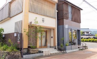 The small inn exterior beside a street.