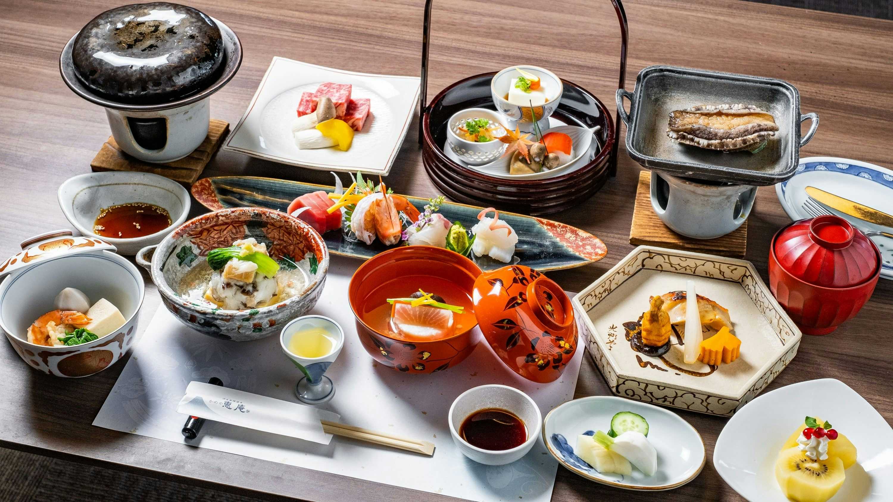 Kameya Ean with a multi-course Japanese dinner arranged across red lacquerware.