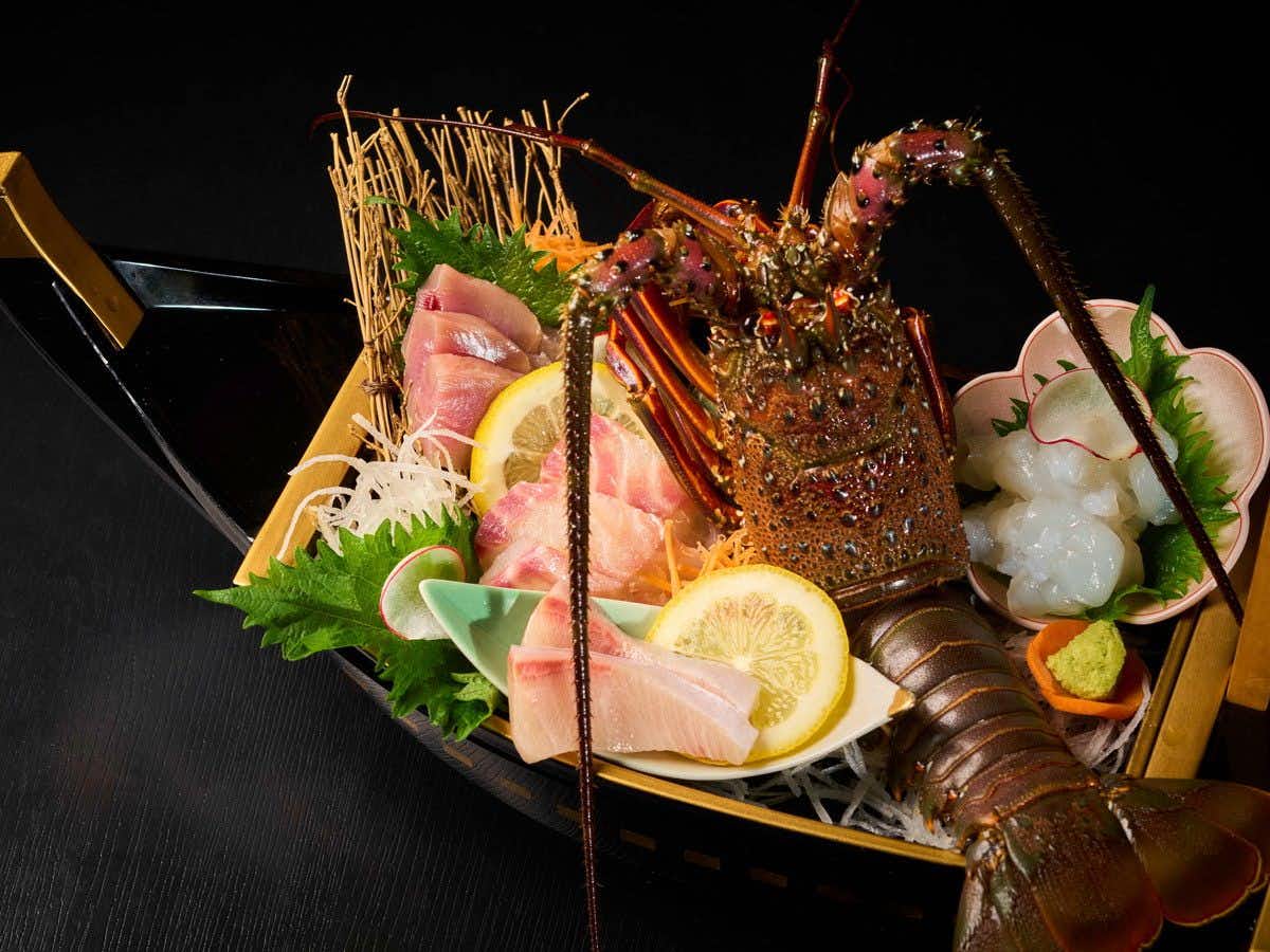 Kutsurogi no Yado Misaki with fresh lobster sashimi presented with citrus and wasabi.