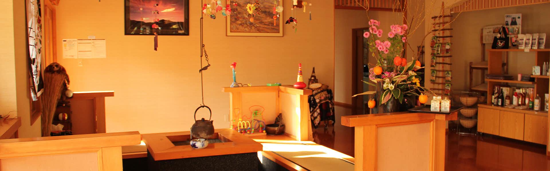 Yasuragi no Yado Matsuya with a welcoming reception counter decorated with flowers and artwork.