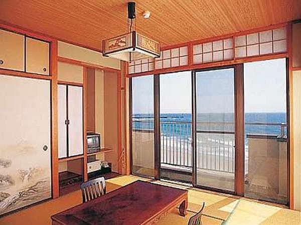 Ryokan Kanemoto with a tatami room opening to a blue ocean balcony.