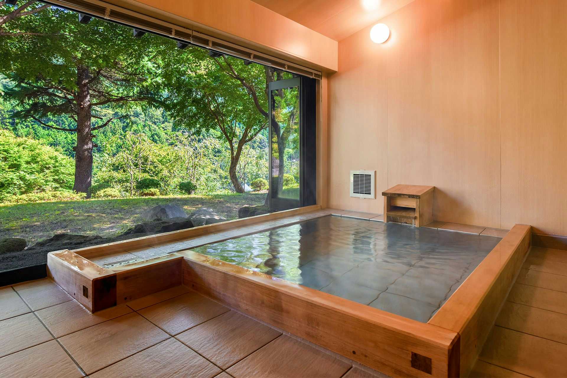 Kawaba Onsen Clear Stream Village Kinshu Sanso with a private indoor bath beside a broad garden window.