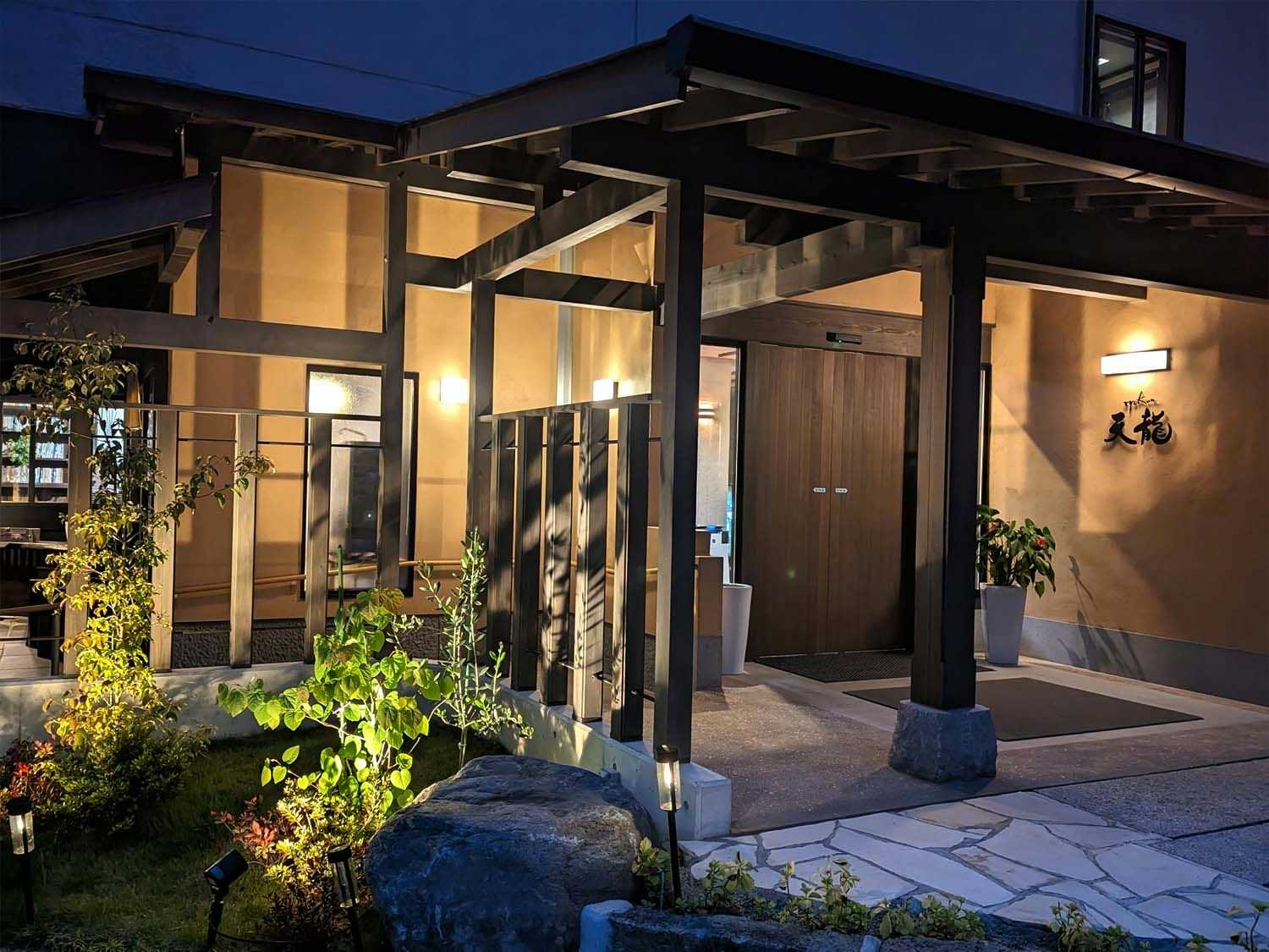 ryokan tenryu with a lantern-lit entrance framed by timber screens and garden stones.