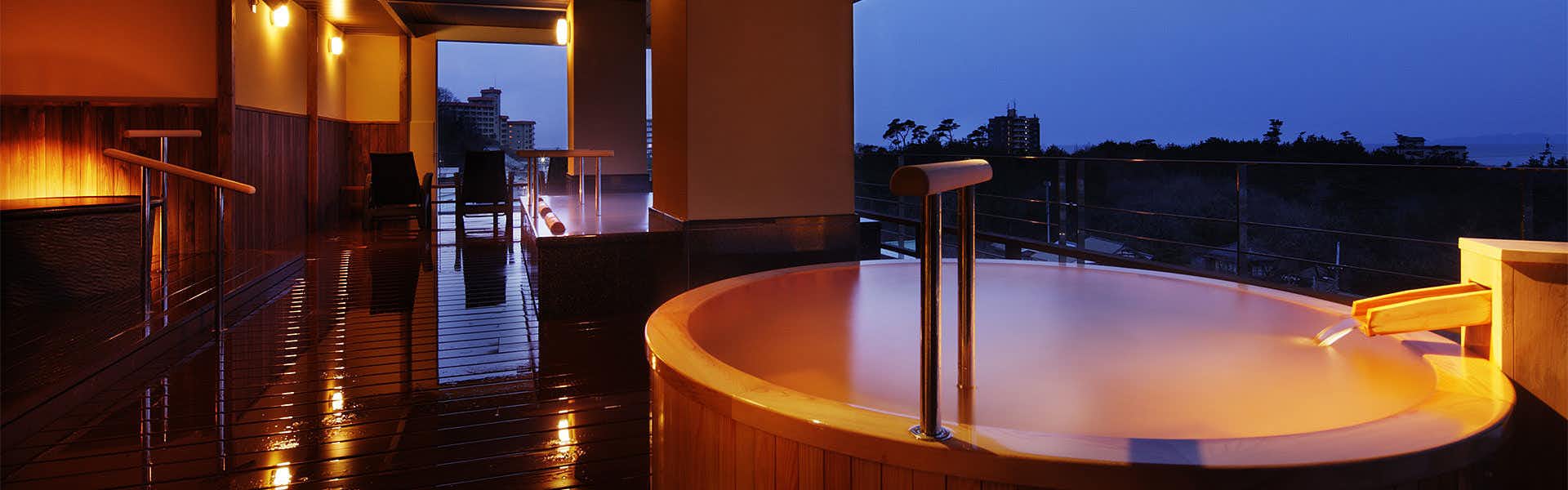 Senami Grand Hotel Haginoya with a private round bath glowing on an open terrace.
