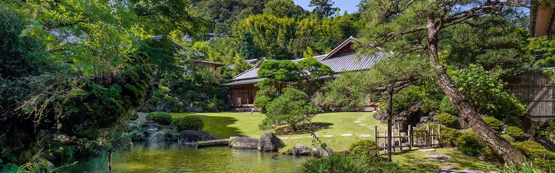 Ryotei Ryokan Atami Koarashitei with this scene, where the ryokan’s landscaped garden surrounds a pond and traditional pavilion.