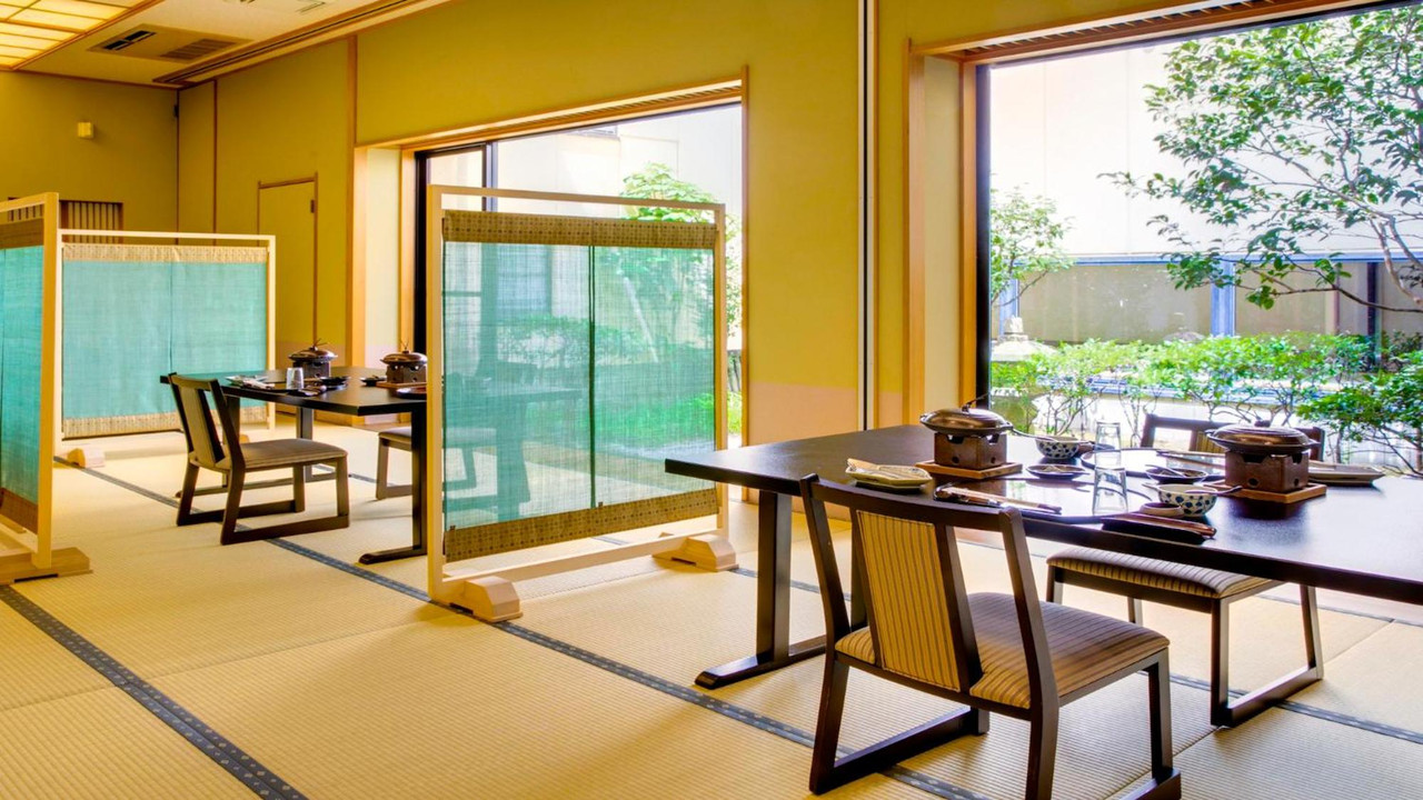 A dining room with tables and chairs.