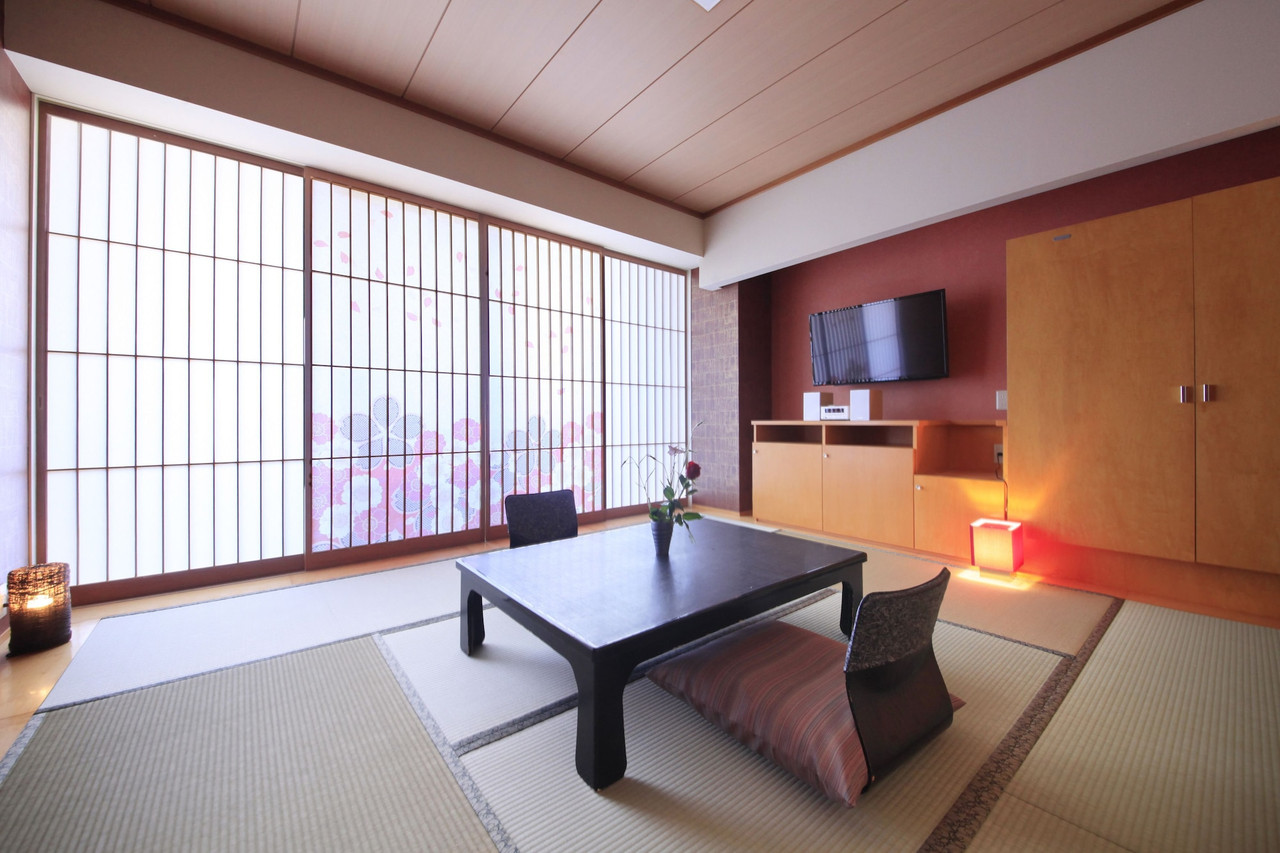 A Japanese-style room with a low table and chairs.