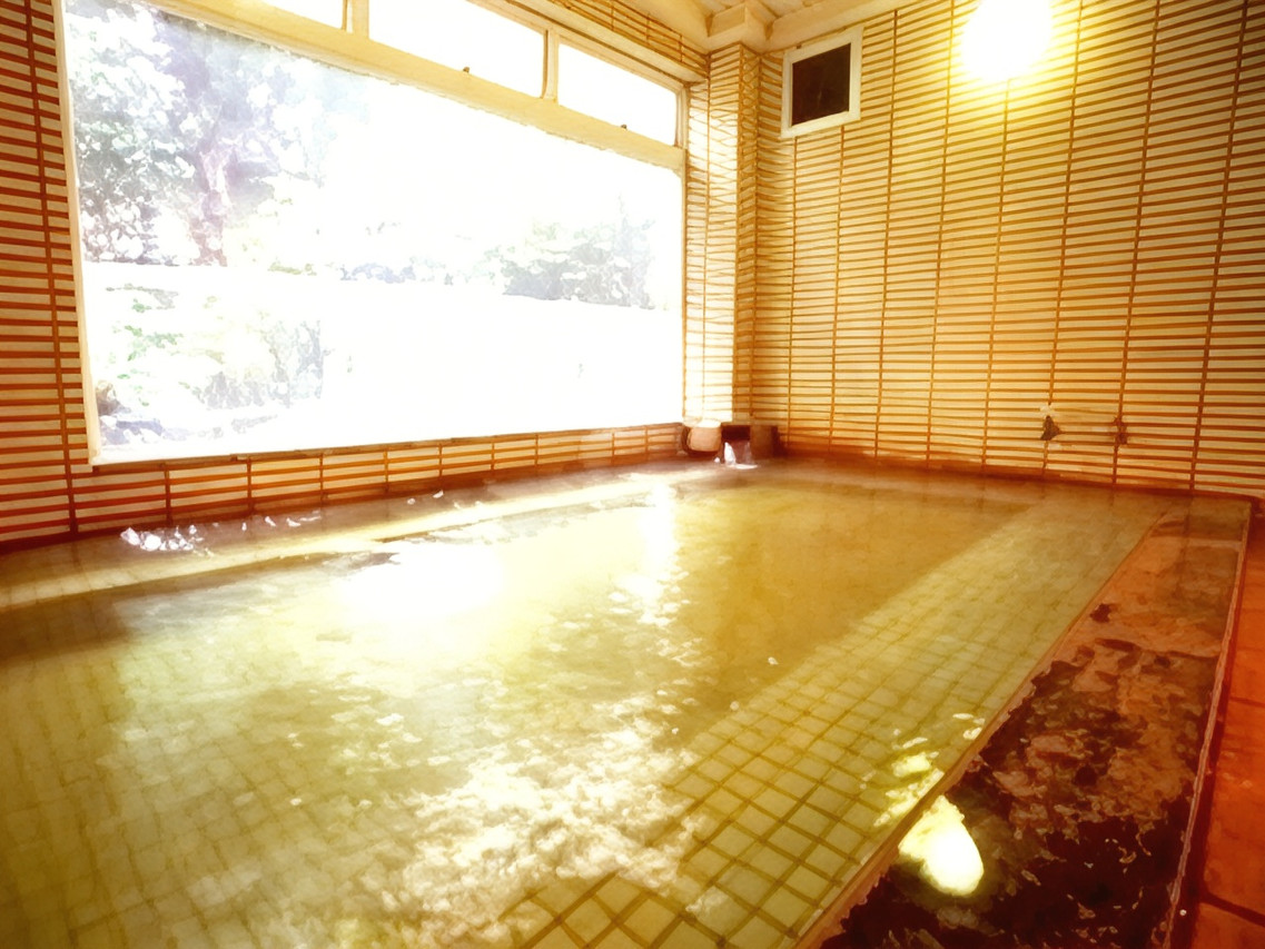 An indoor bath beside a broad window.