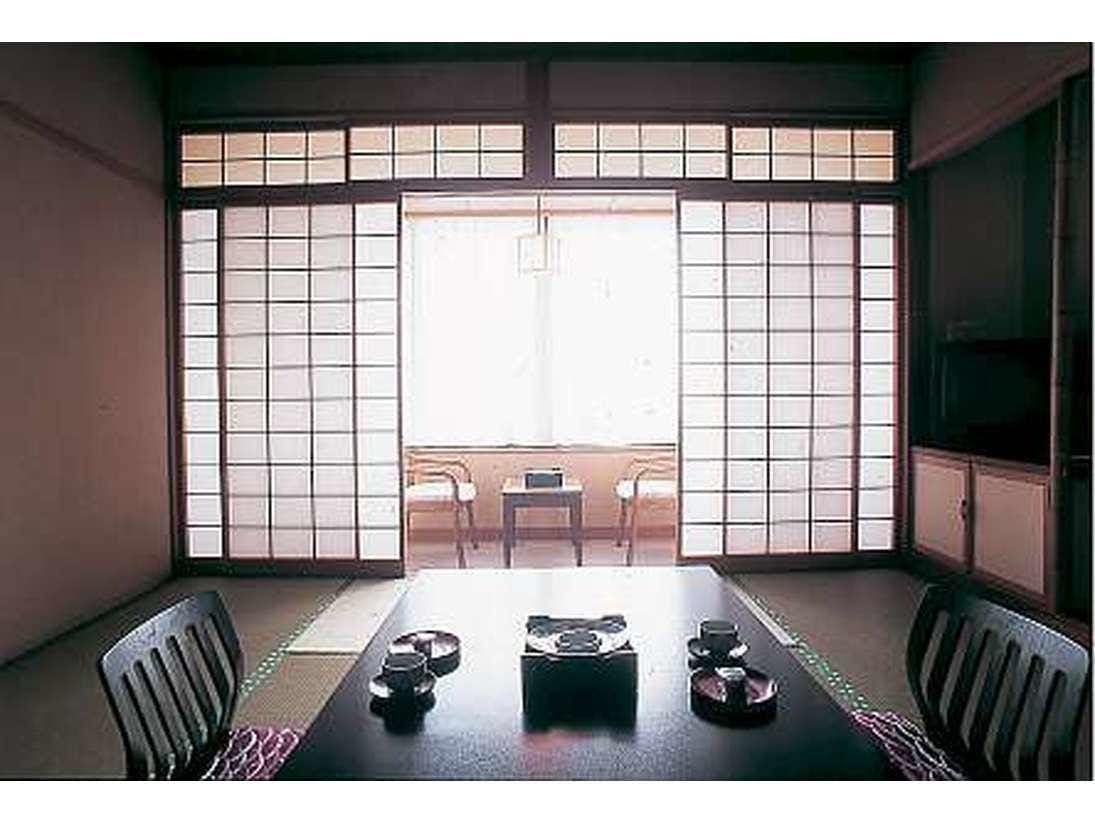 Seafood Inn Ryotei Kotaki with an intimate dining room set with low timber tables.