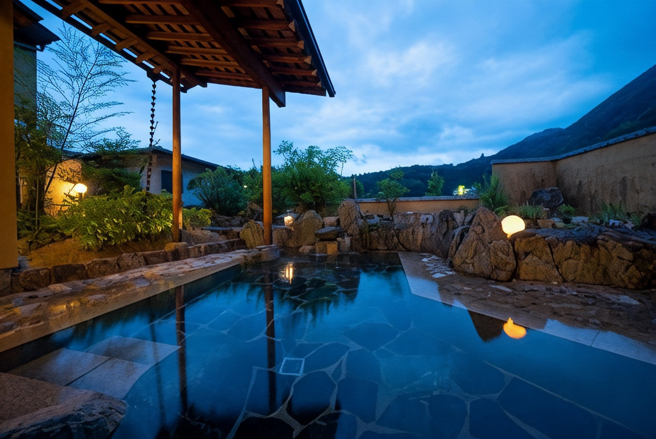 Outdoor bathing pool beneath a covered wooden roof.