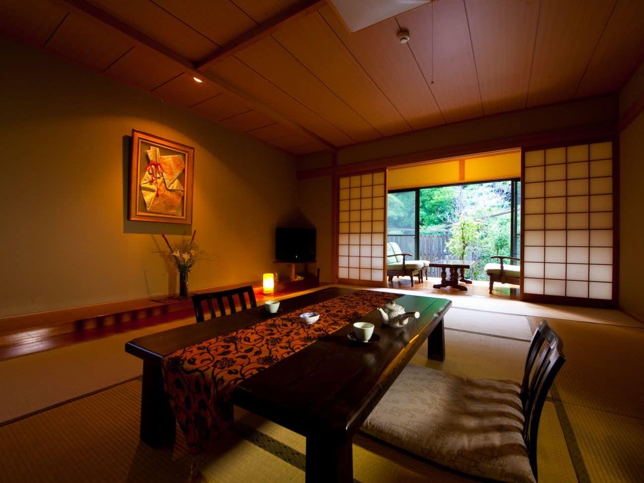 Yufuin Taiha with a warm tatami room with low table and garden windows.