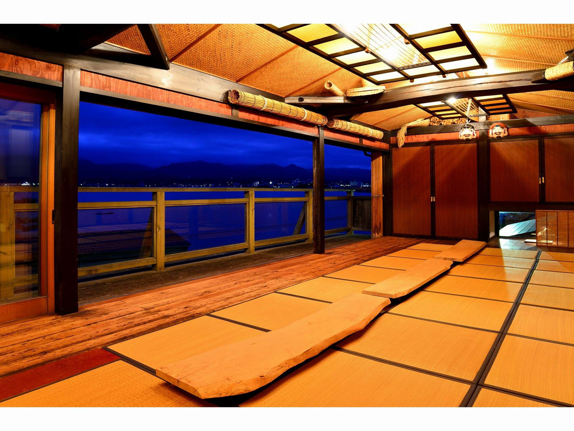 A tatami room opening onto a water view.