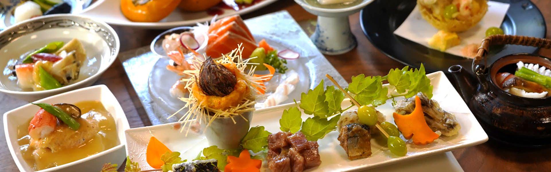 Tabisou Yufuin Yamadaya with a multi-course dinner arranged across white plates.