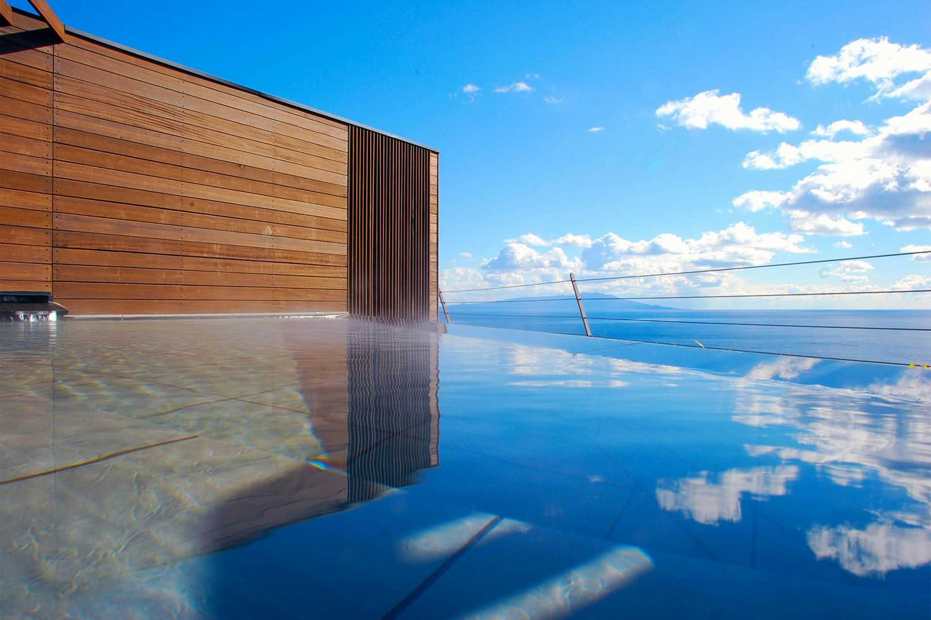 Atagawa Prince Hotel with the rooftop infinity pool overlooking the blue Pacific coastline.