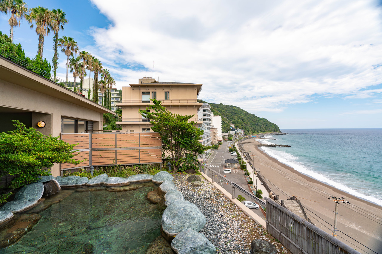 Property exterior above a coastal road and beach.
