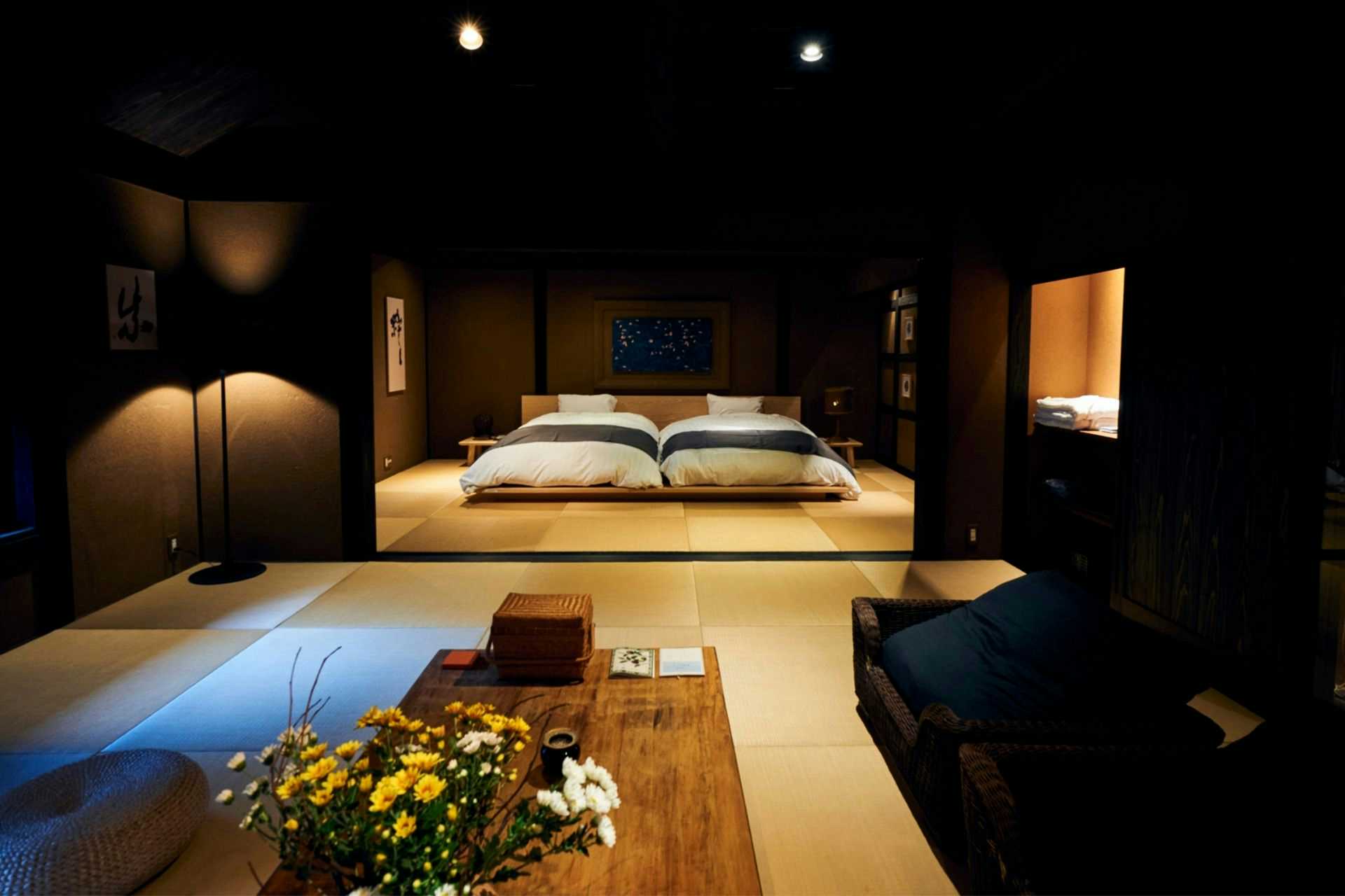 Yunotsuru guest place Tsurunoya with a refined bedroom with low bed and timber details.