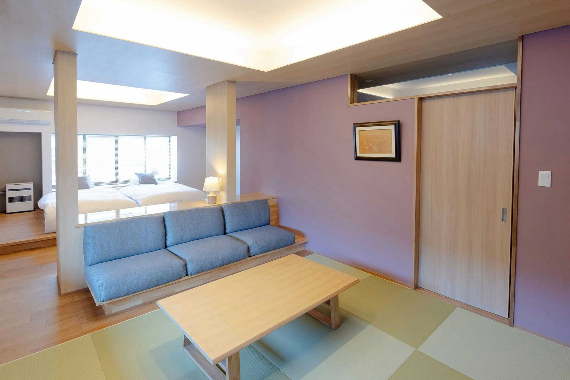 Onogawa Onsen Takasagoya with a modern tatami sitting room with blue sofa and low table.