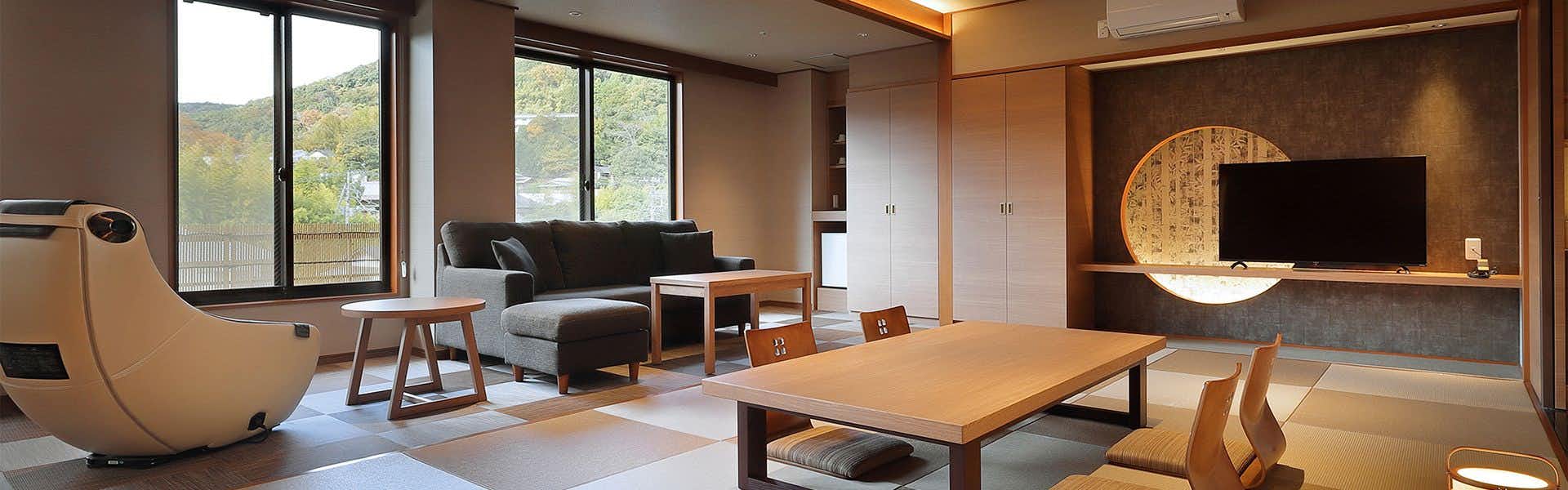 Mizuno Sato Marukyu Ryokan with a modern suite with massage chair and garden-facing windows.