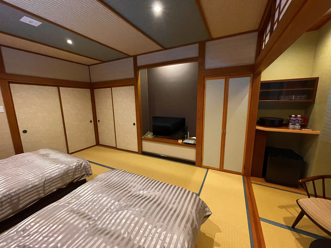 A tatami room with a low table and sliding screens.