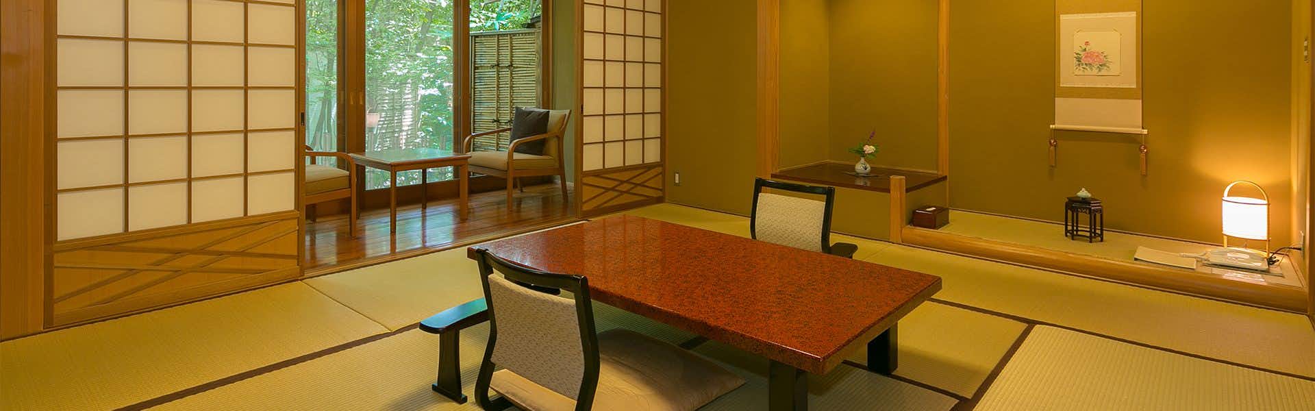 Yufuin Onsen Hinoharu Ryokan with a calm tatami room with low table and window seating.