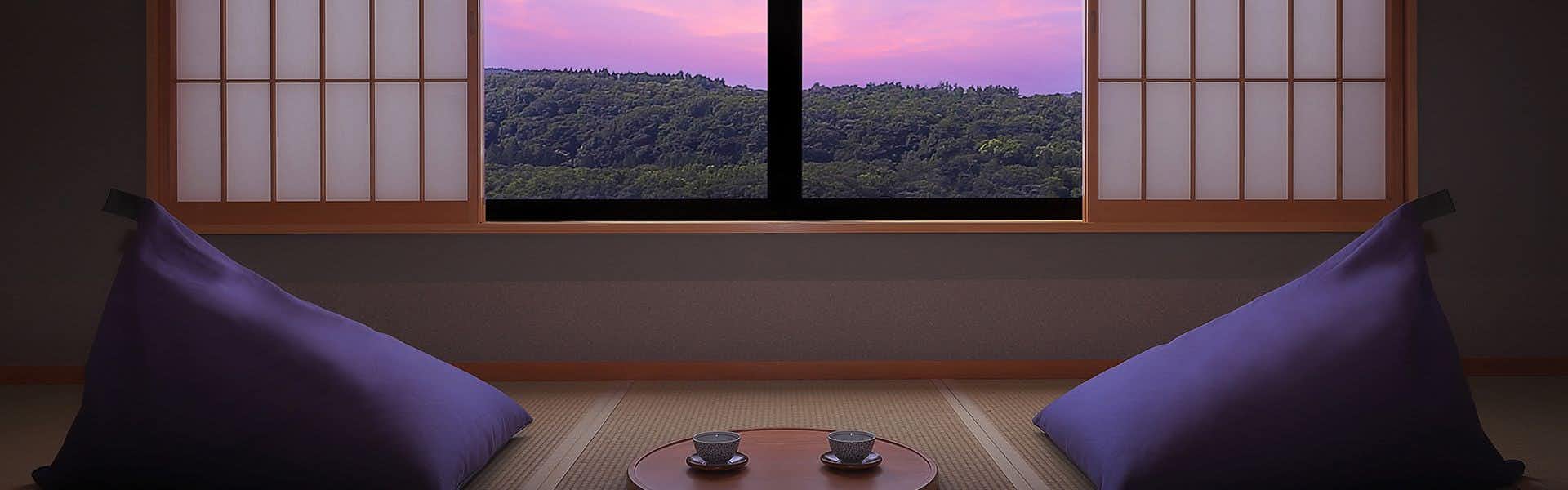 Ryokan Sanjiro with a cushioned window nook framing distant mountain ridges.