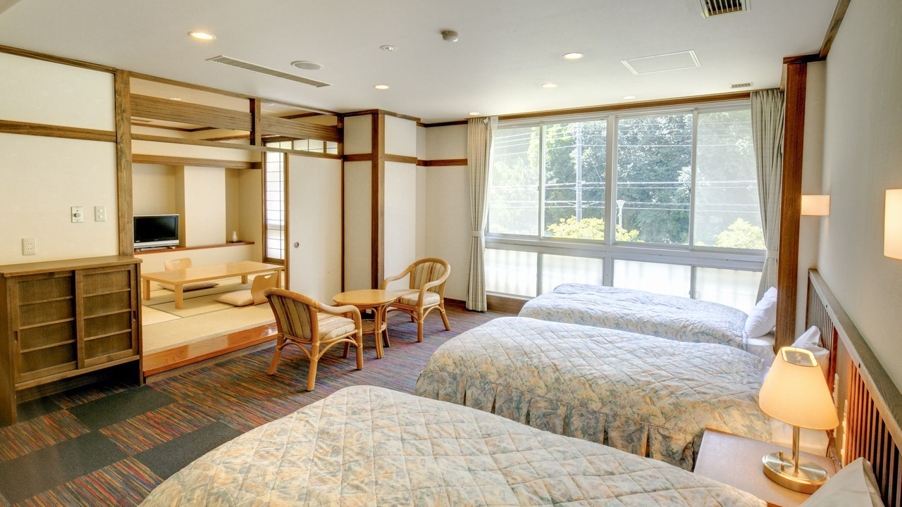 A simple room combines a bed with a low seating area.