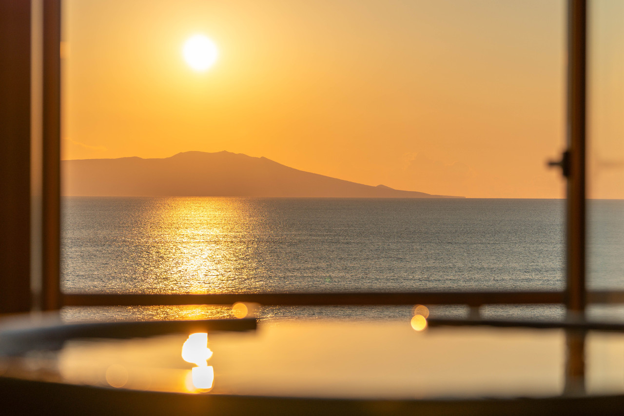 Sunset over the sea seen through a window.