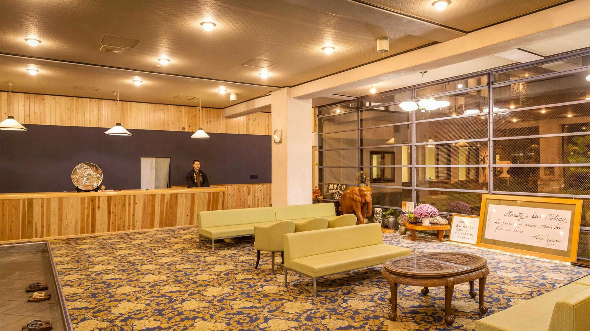 Bandai Nishimuraya with a modern reception lobby with pale sofas and glass walls.