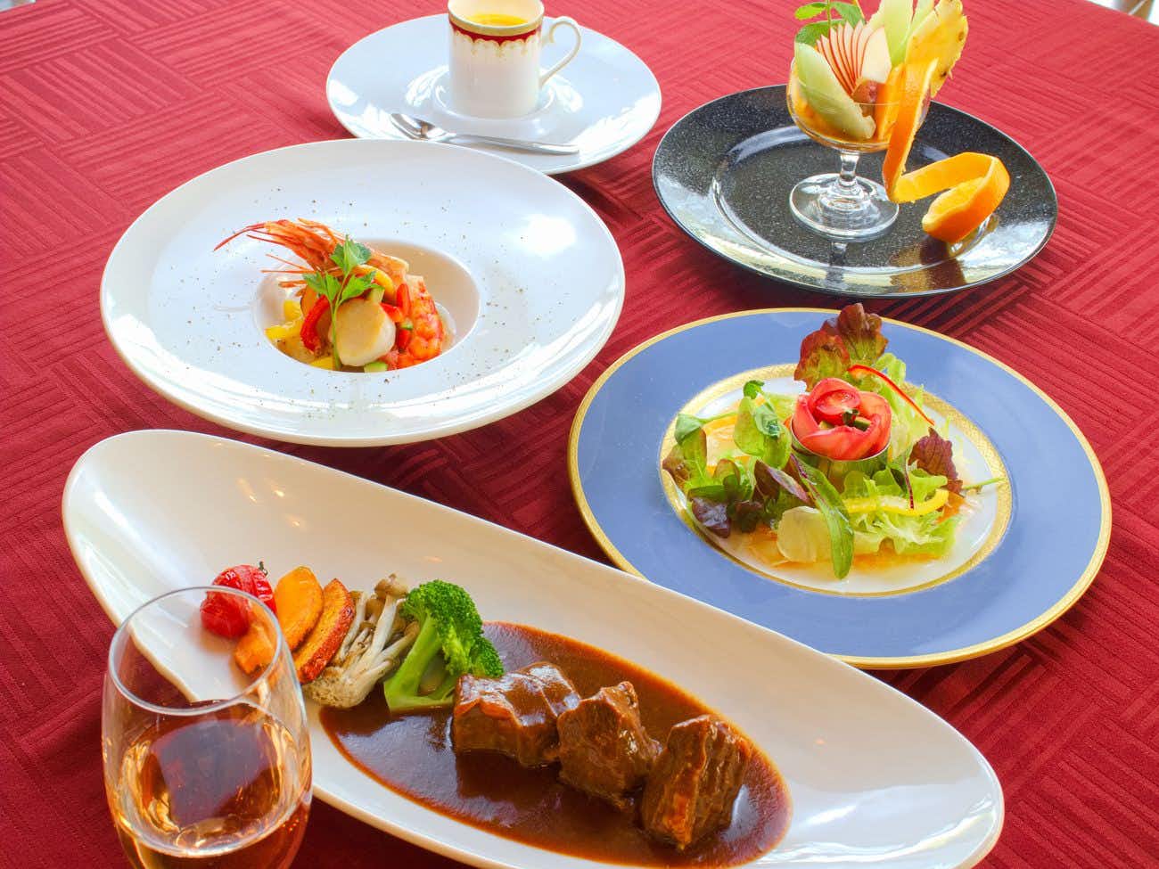 Tokiwasure with a plated western dinner with salad and colorful desserts.