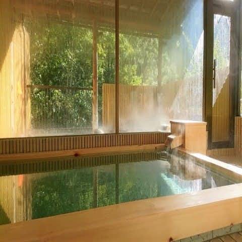 Yatsugawakan rectangular indoor bath beside misted forest windows