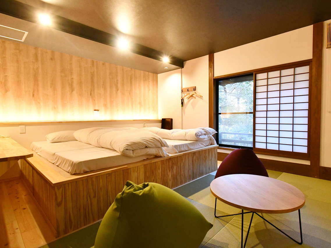 A wood-lined sleeping area includes a low table and shoji screens.