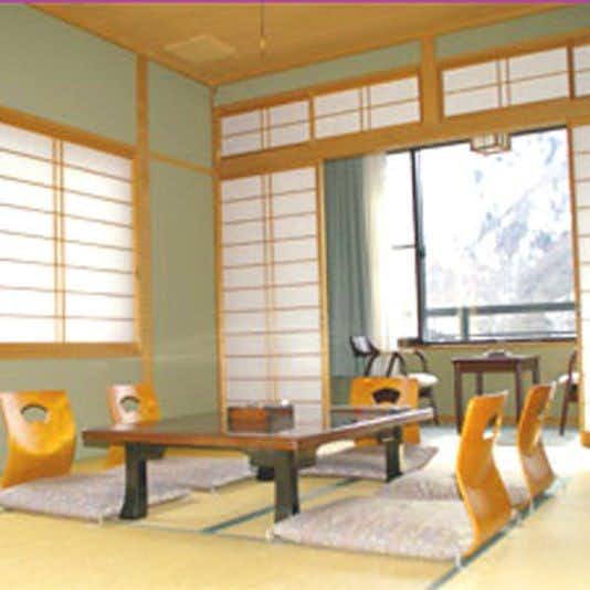 Hirayu Onsen Ryokan Tanaka with this scene, where a bright tatami room centers a low table beneath shoji transoms.