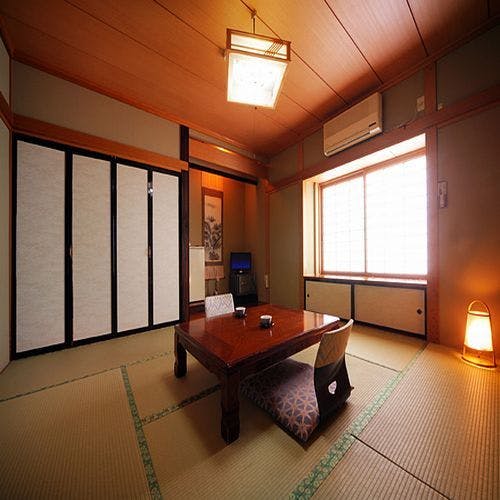Semi Onsen with a warm tatami room with low table and shoji screens.
