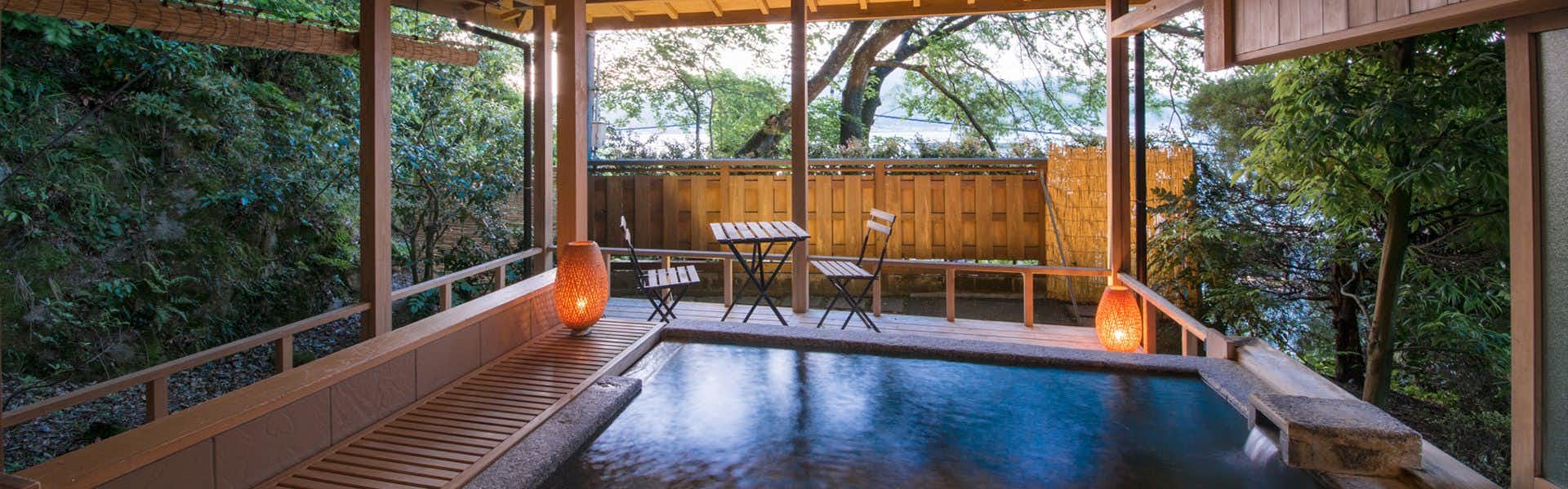 Hotel Kitanoya with a private bath framed by broad garden windows.