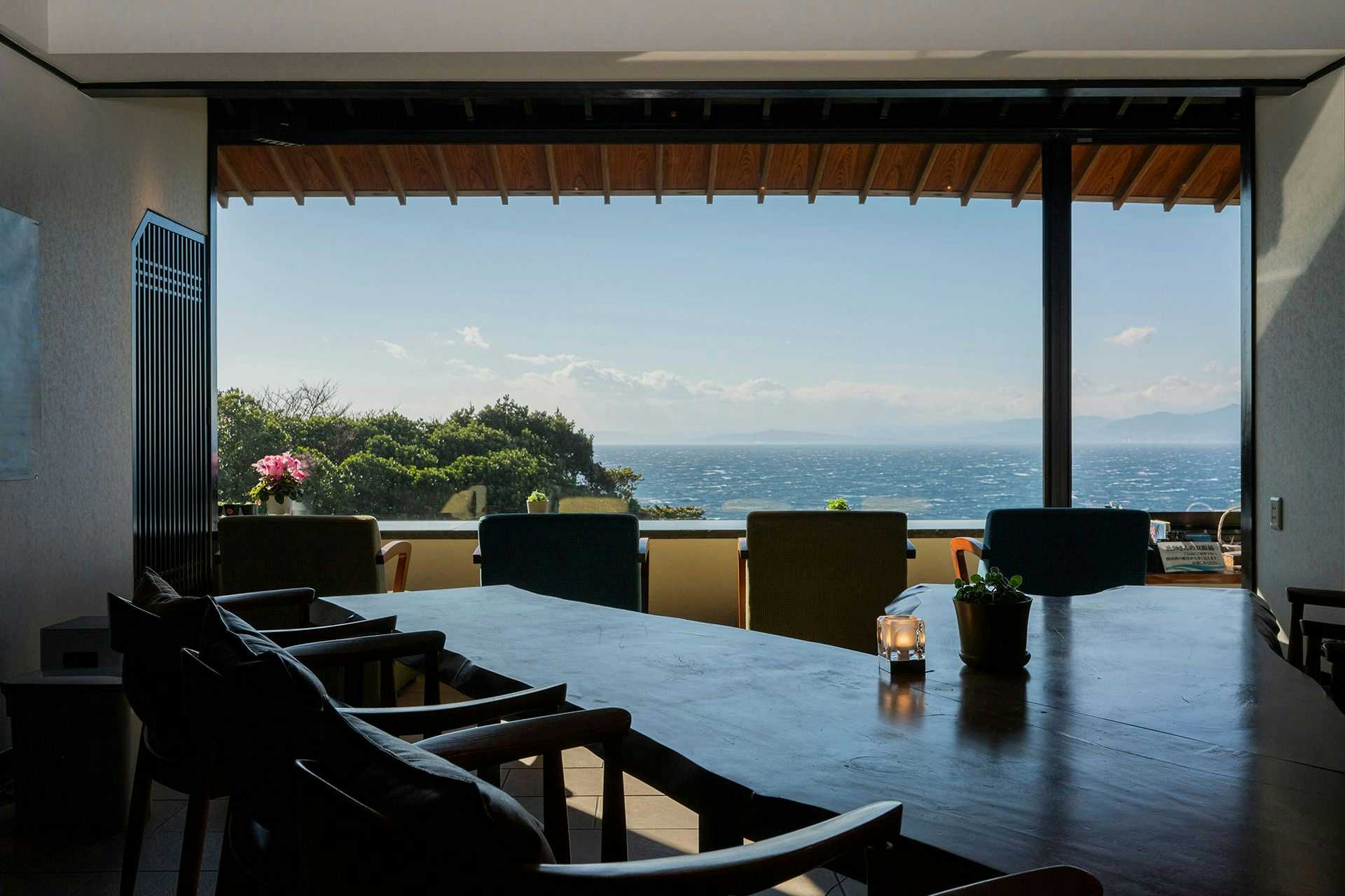 Nishi-Izu Dining Nishi-Izu Koyoi with a dining room with panoramic windows overlooking the blue ocean.