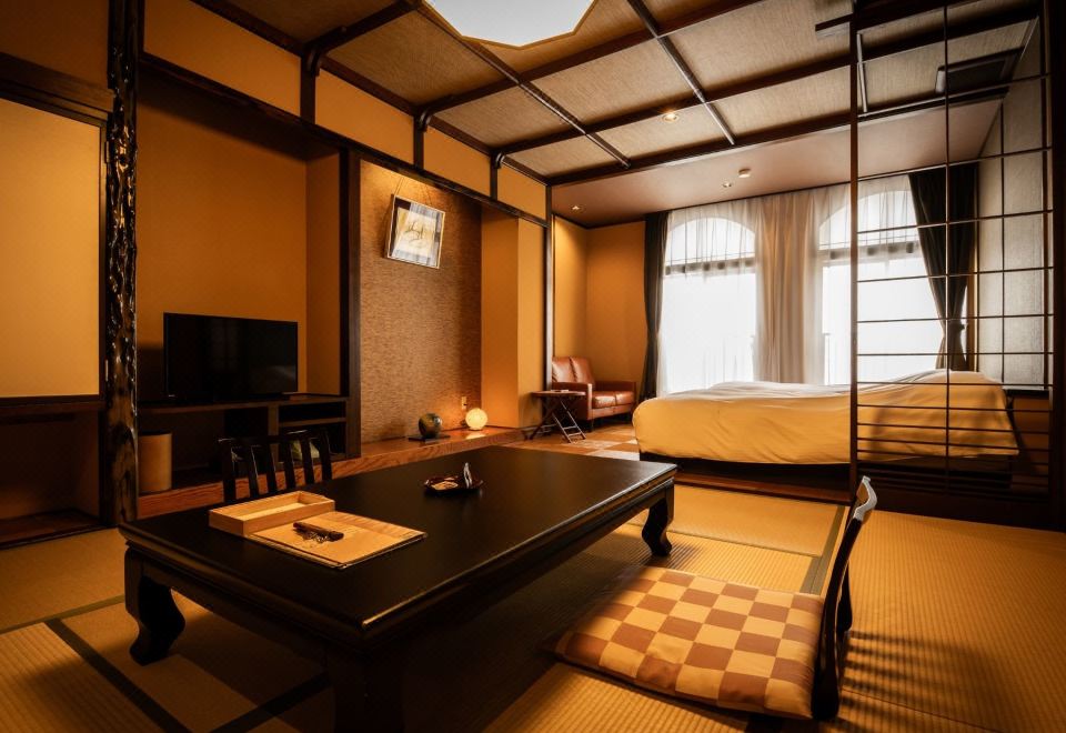 A tatami bedroom with a raised bed and low table.