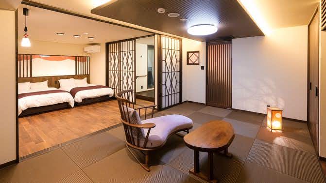 Awara Onsen Hasegawa with a contemporary tatami suite with twin beds and low lounge chairs.
